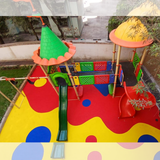 EPDM playground flooring in red yellow and blue around kids play equipment