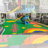 Green EPDM playground flooring with colorful hopscotch numbers stars and activity designs